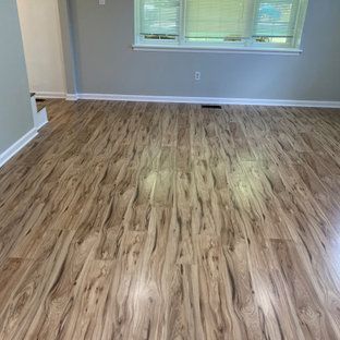A living room with hardwood floors and a window.