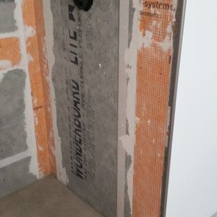 A door is being built into a wall in a bathroom.