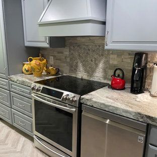 A kitchen with a stove , oven , dishwasher , and coffee maker.