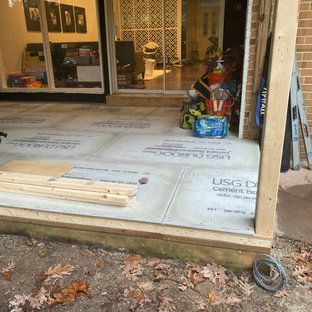 A sliding glass door is being built on the side of a house.