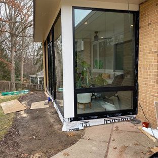 A house with a lot of windows on the side of it.
