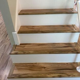 A close up of a set of wooden stairs with white steps.