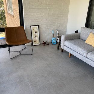 A living room with a couch , chair , guitar and starfish.