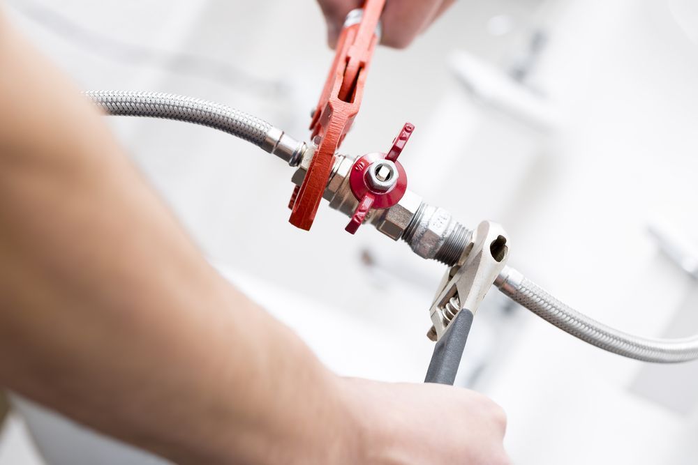 Hands Using Wrenches to Tighten a Valve — Tapped Out Plumbing NT in Bellamack, NT