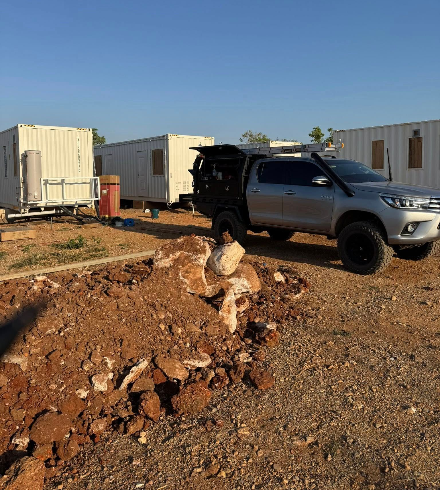 Silver Pickup Truck Parked Near Modular Buildings — Tapped Out Plumbing NT in Bellamack, NT