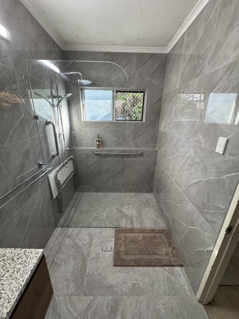 Bathroom With Grey Marble-look Tile, Glass Shower Door — Tapped Out Plumbing NT in Bellamack, NT
