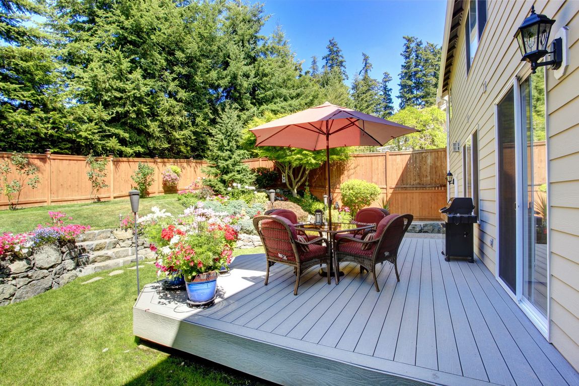 backyard with wooden fence and deck