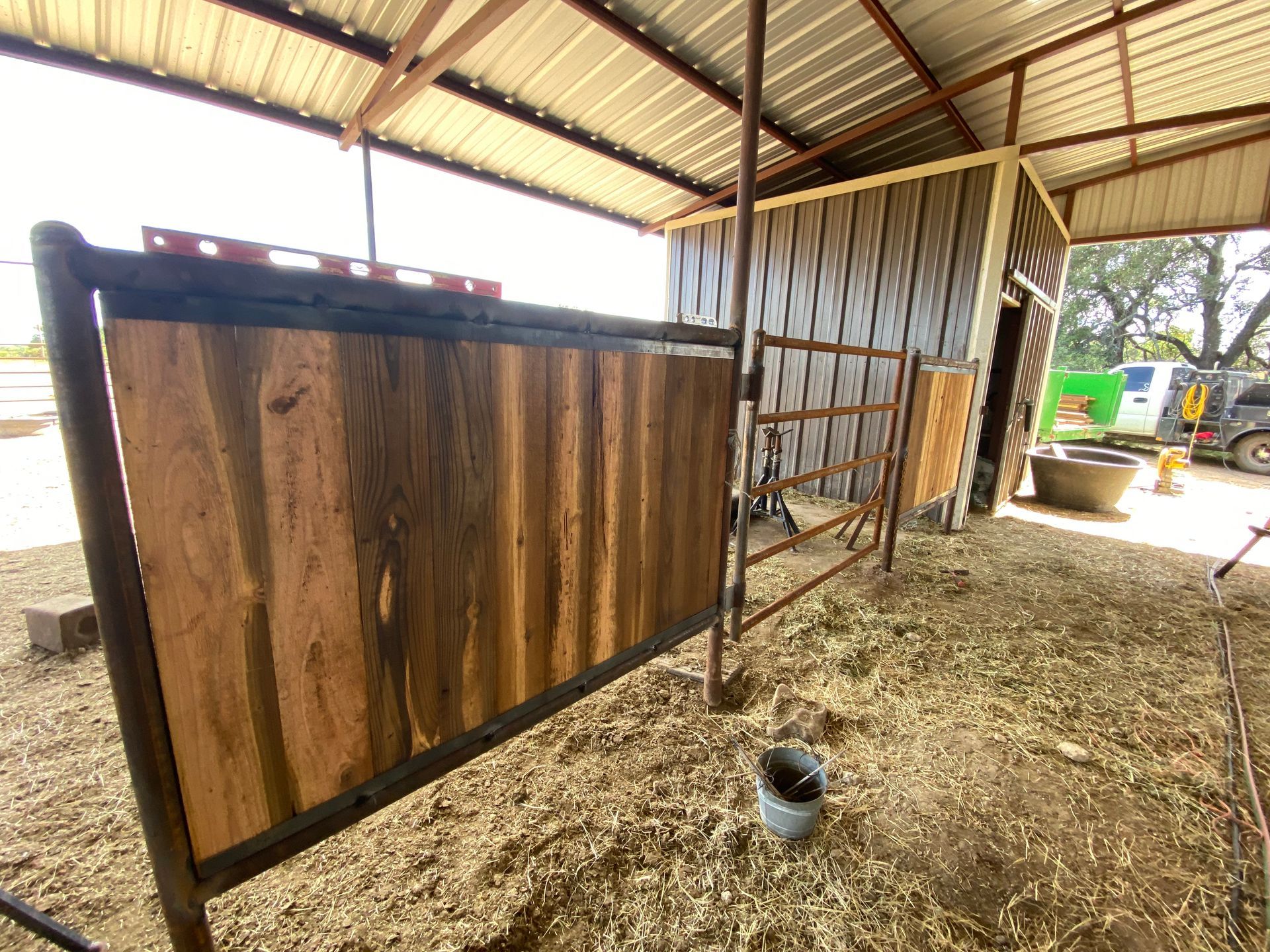 A wooden fence is sitting in the middle of a barn.