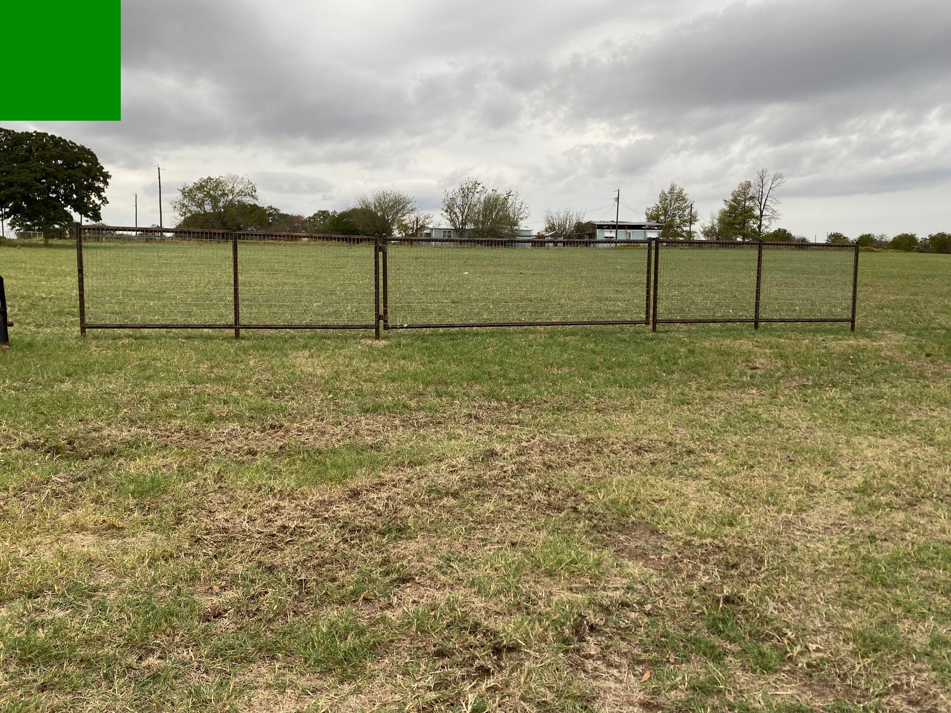 A field with a fence in the middle of it