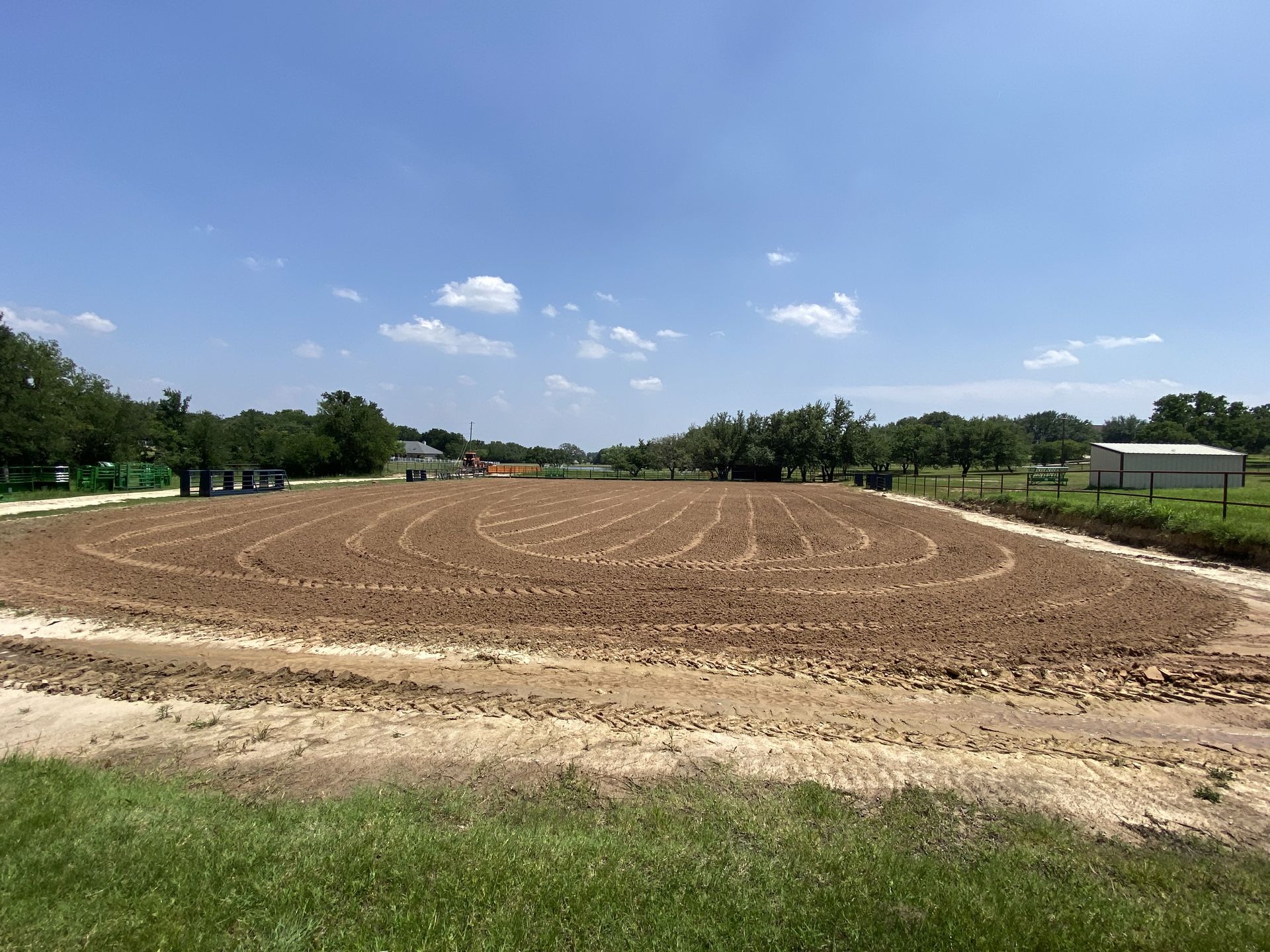 A large dirt field with a labyrinth in the middle of it.