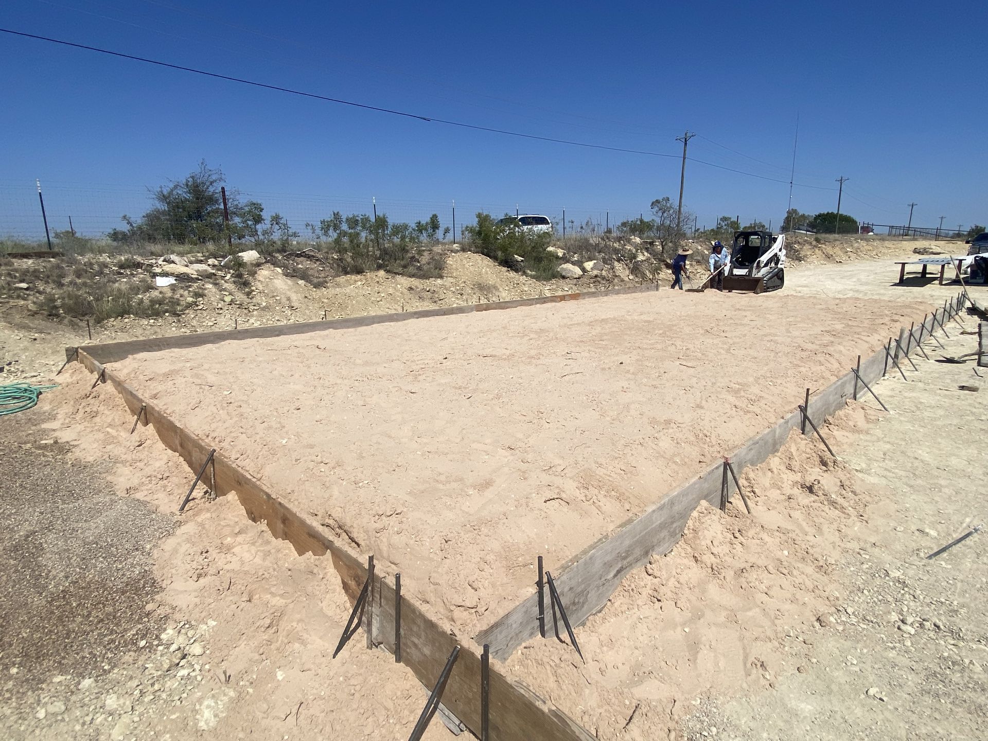 A construction site with a bulldozer in the background