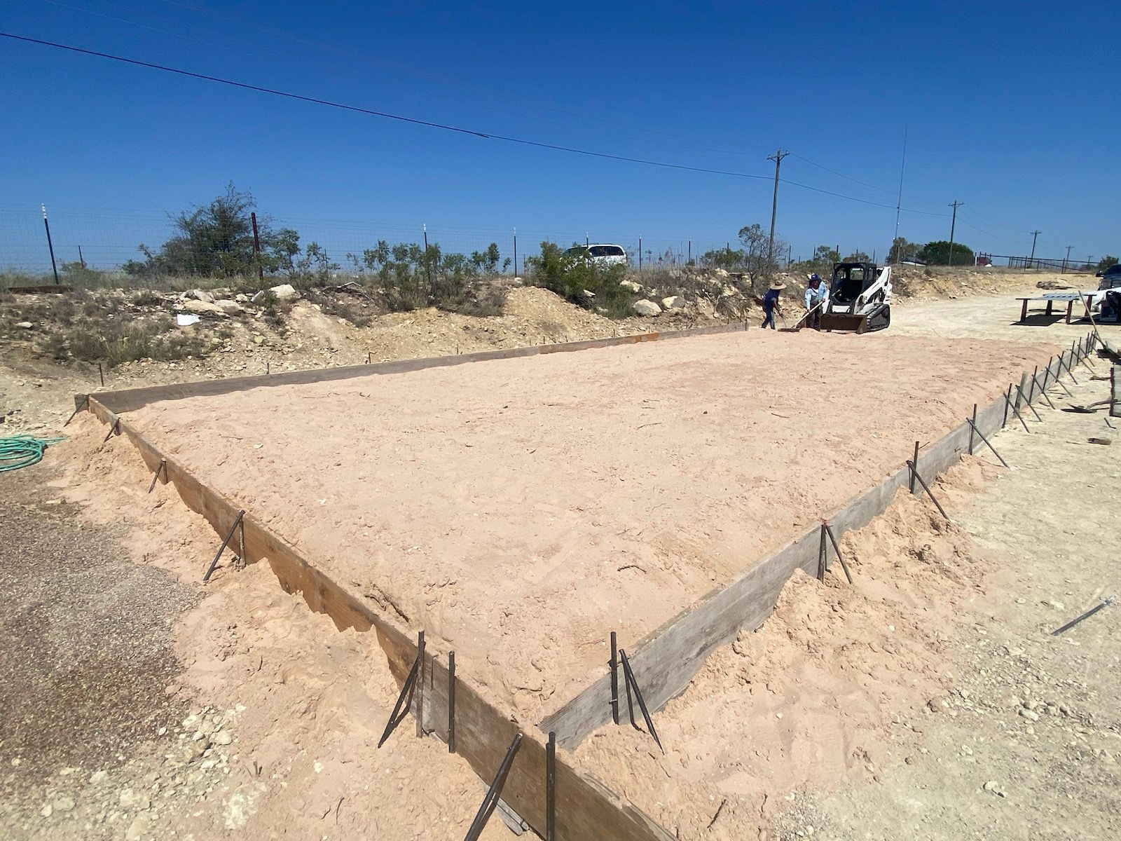 A concrete foundation is being built in the desert