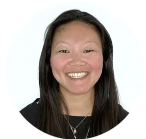 A woman wearing glasses and a black shirt is smiling