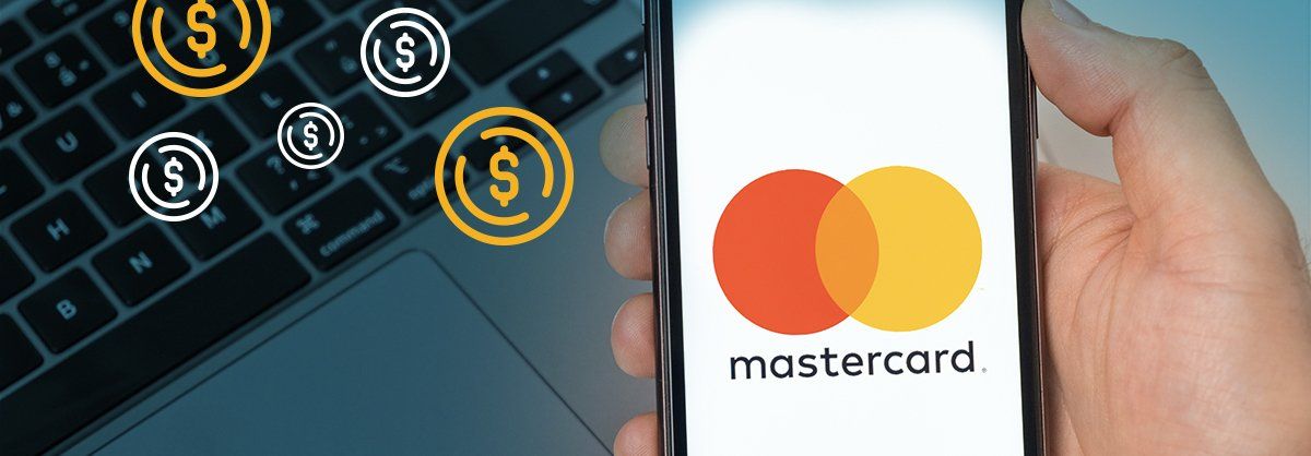 Close up of hand holding mobile phone with Mastercard logo on the screen