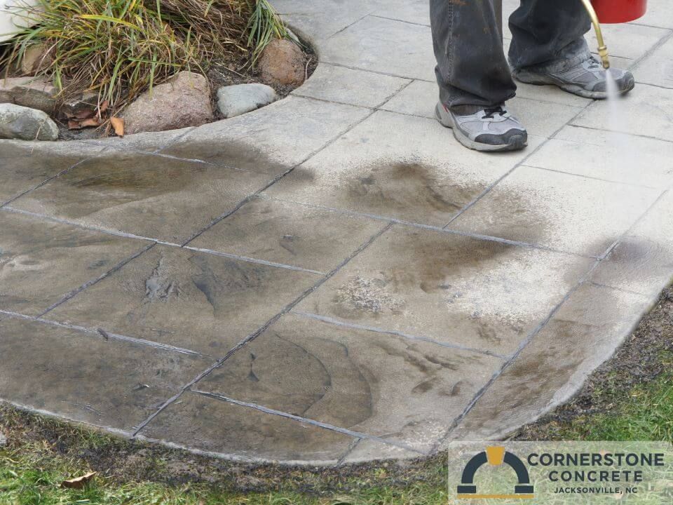 Decorative stamped concrete patio with stone texture installed in Jacksonville NC by Cornerstone Concrete.
