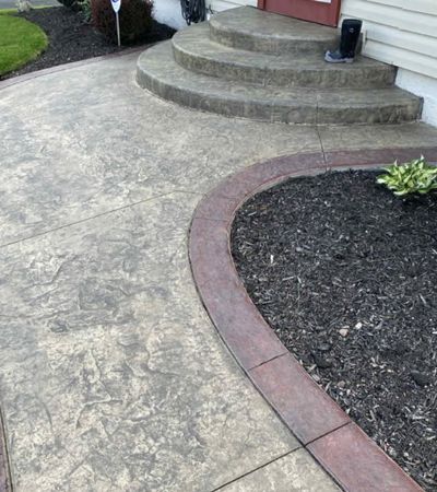 Stamped concrete patio and curved walkway finished in decorative texture