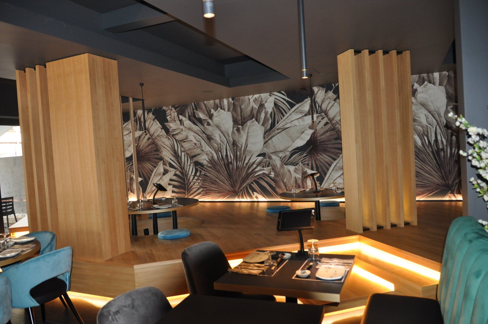 Un ristorante con tavoli e sedie e un grande murale sulla parete