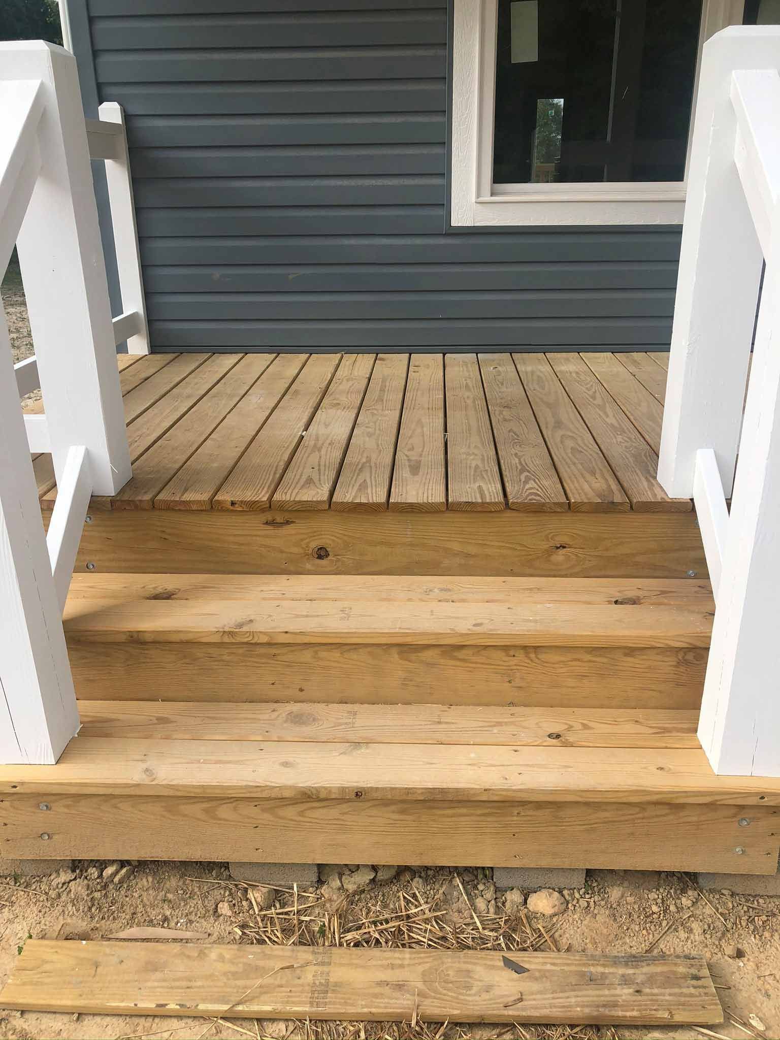 A Wooden Deck With Stairs Leading Up To It And A White Railing — Hendersonville, NC — Chameleon's Painting LLC
