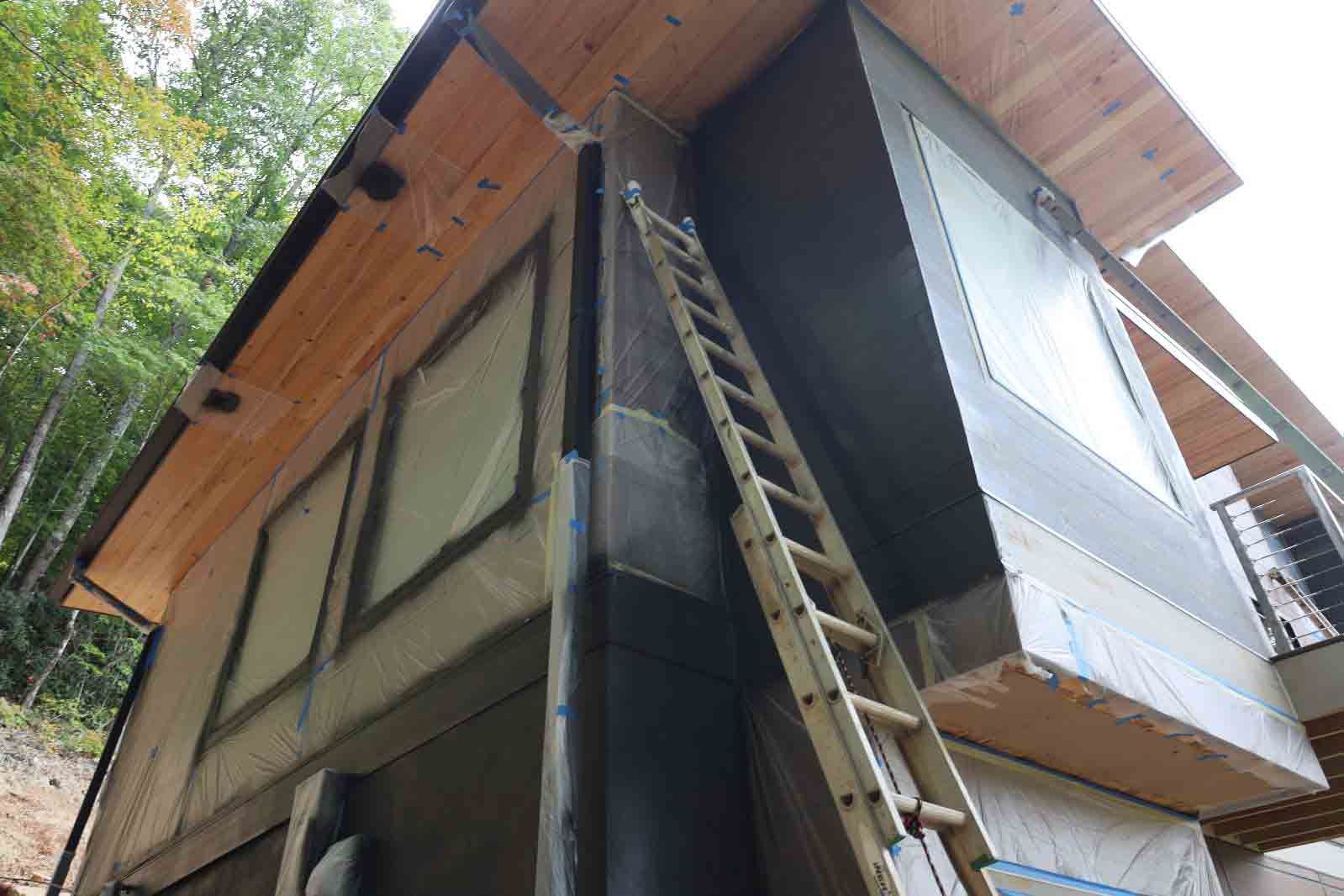 A Ladder Is Leaning Against The Side Of A House — Hendersonville, NC — Chameleon's Painting LLC
