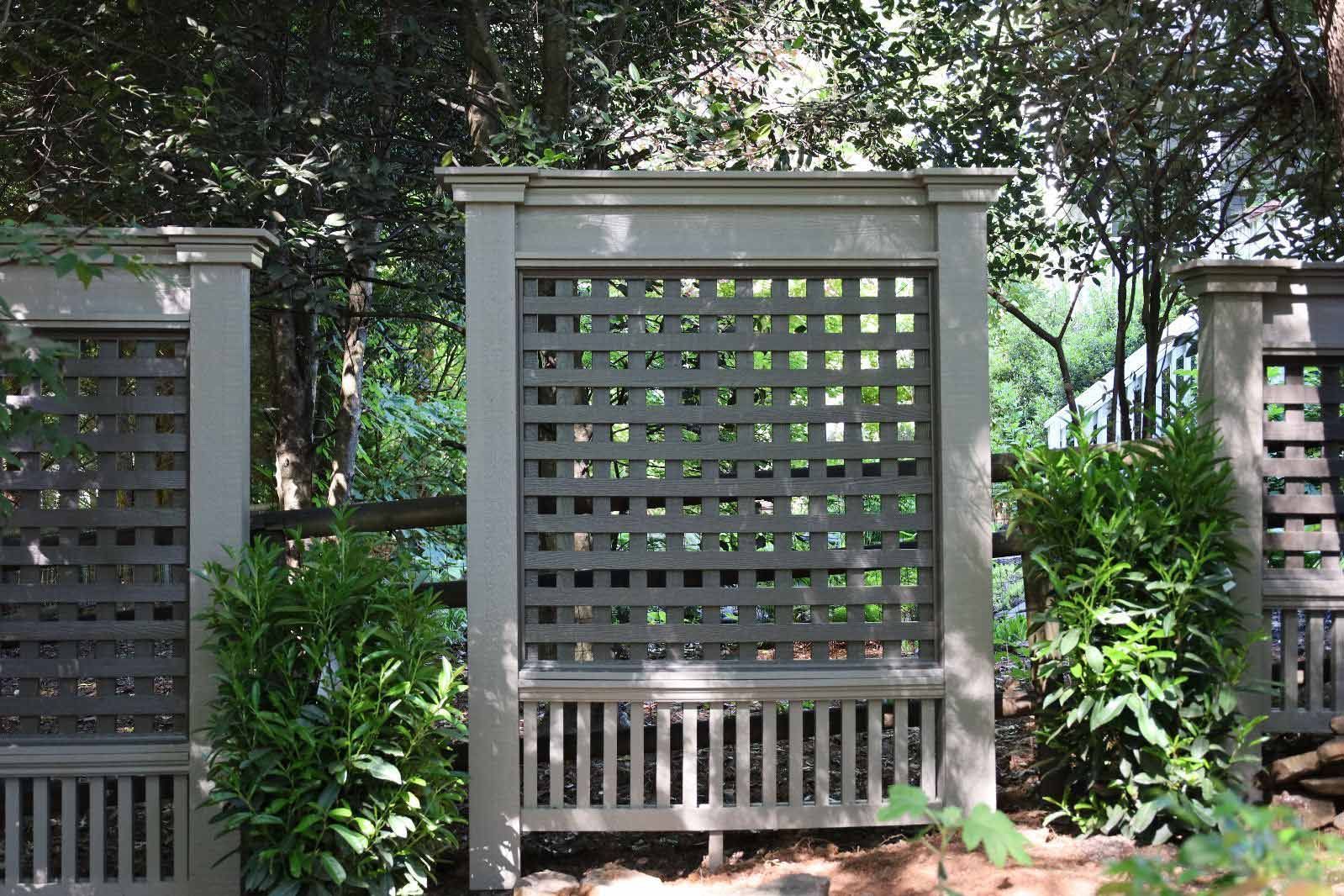 A Wooden Fence Is Surrounded By Trees And Bushes — Hendersonville, NC — Chameleon's Painting LLC
