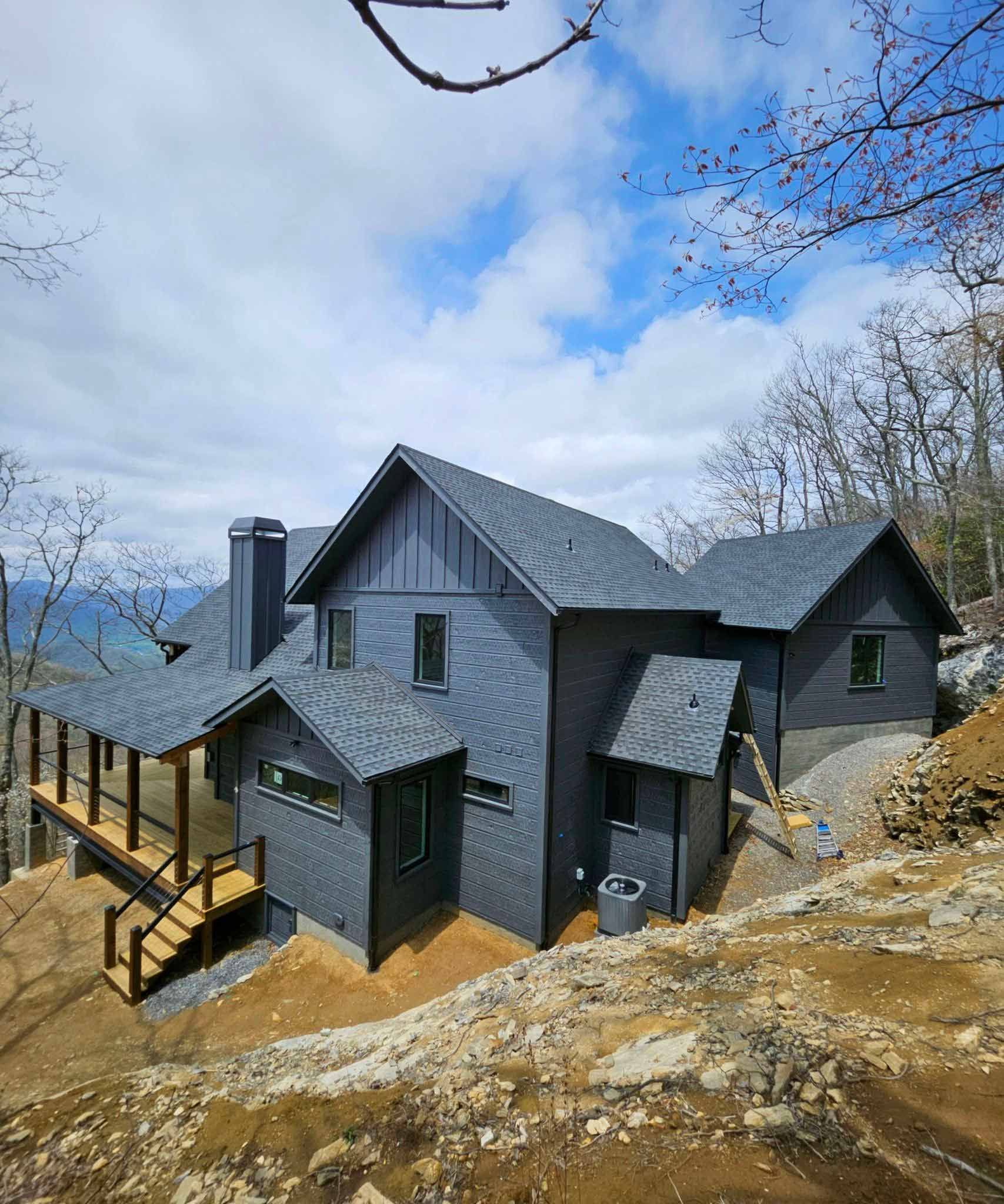 A Large House Is Sitting On Top Of A Hill Surrounded By Trees — Hendersonville, NC — Chameleon's Painting LLC
