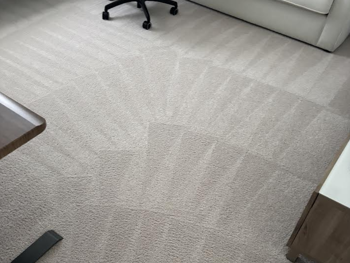 Beige carpeted floor, office setting with chair and furniture.
