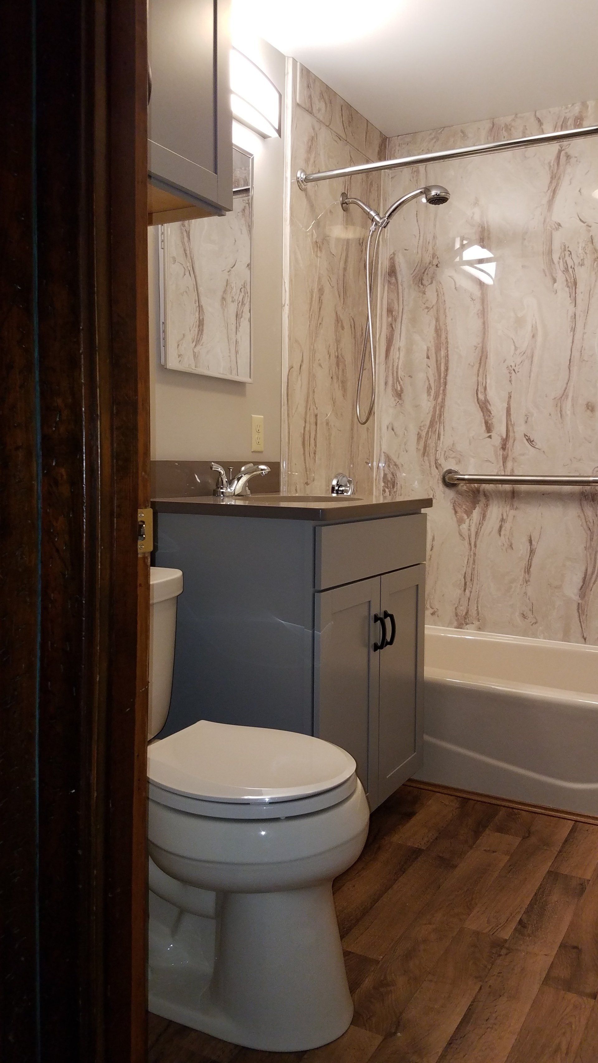A bathroom with a toilet , sink , and bathtub.