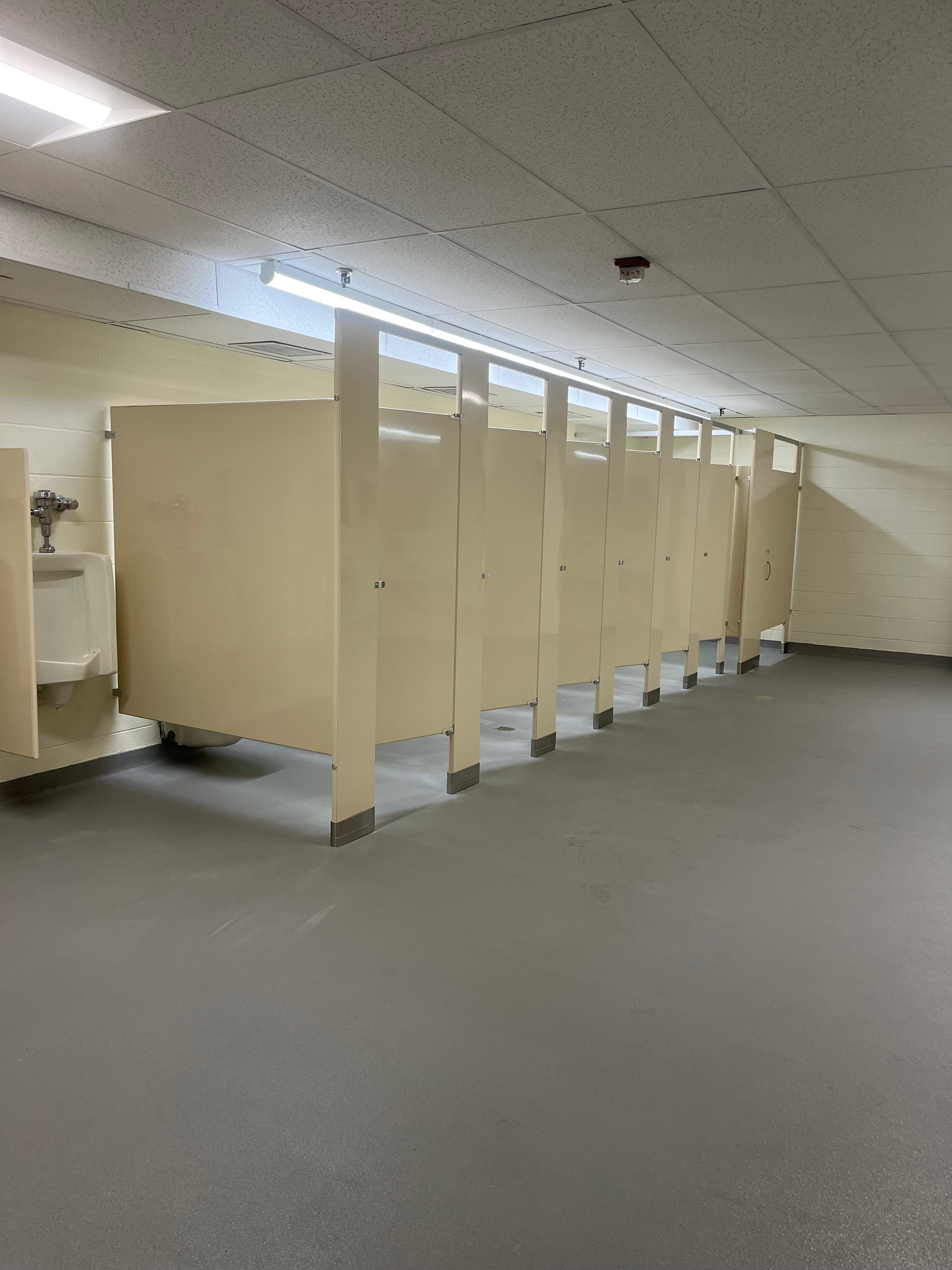 A row of toilet cubicles in a public restroom.