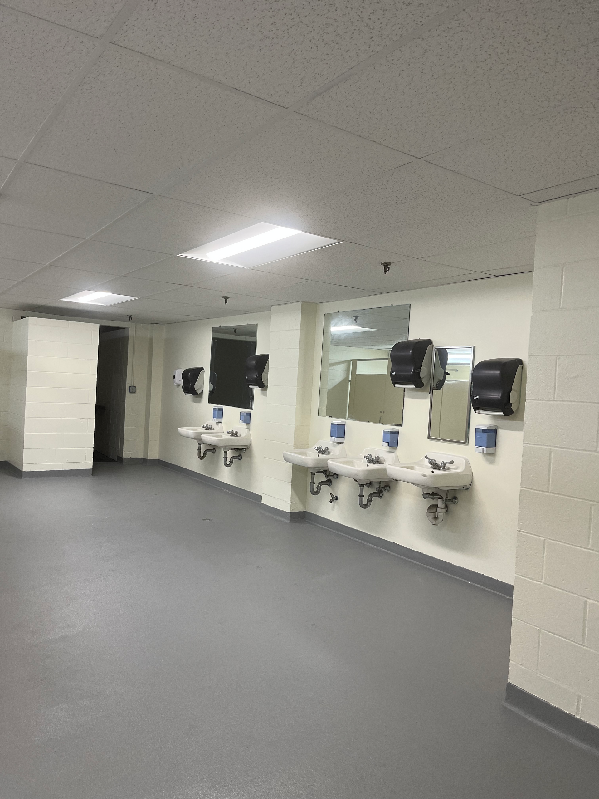 A bathroom with a lot of sinks and mirrors