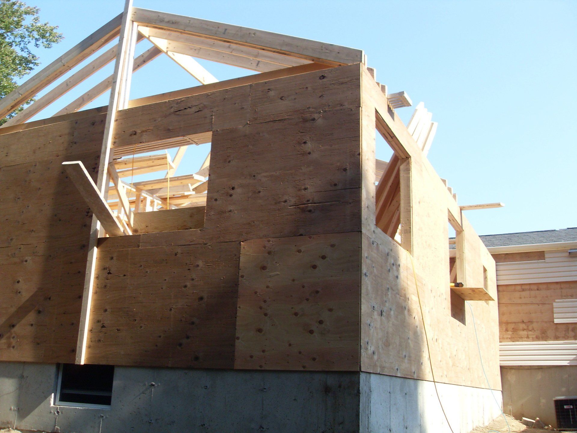 A house under construction with a blue sky in the background