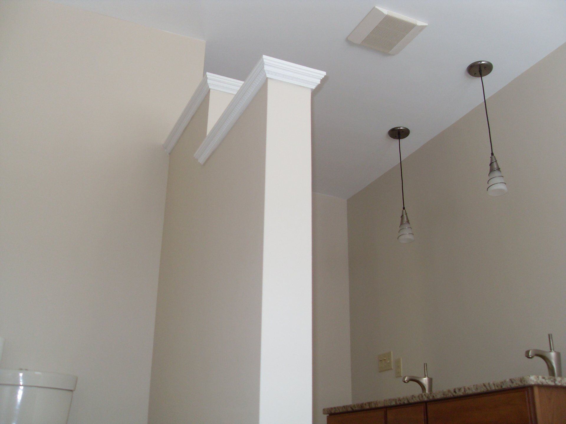 A bathroom with a toilet a sink and a ceiling fan