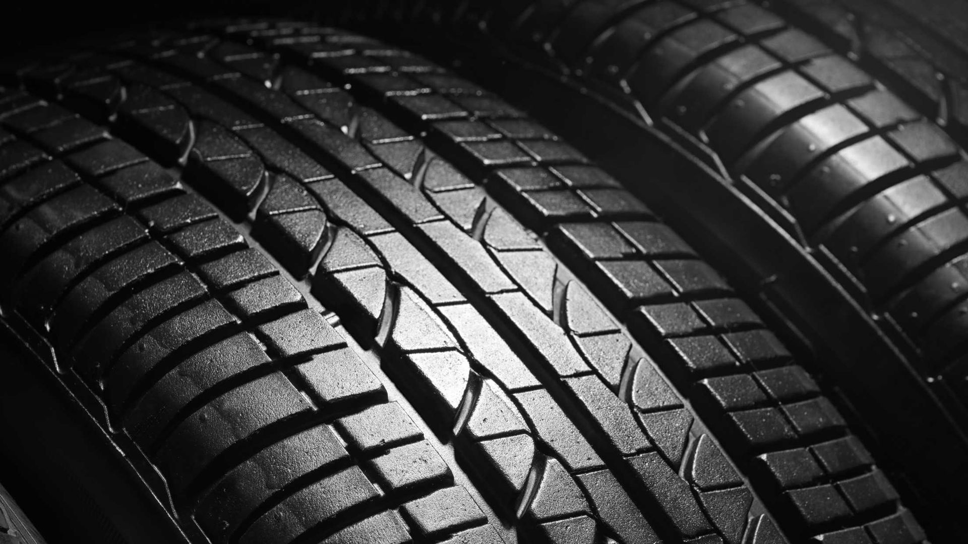 A black and white photo of three tires stacked on top of each other.