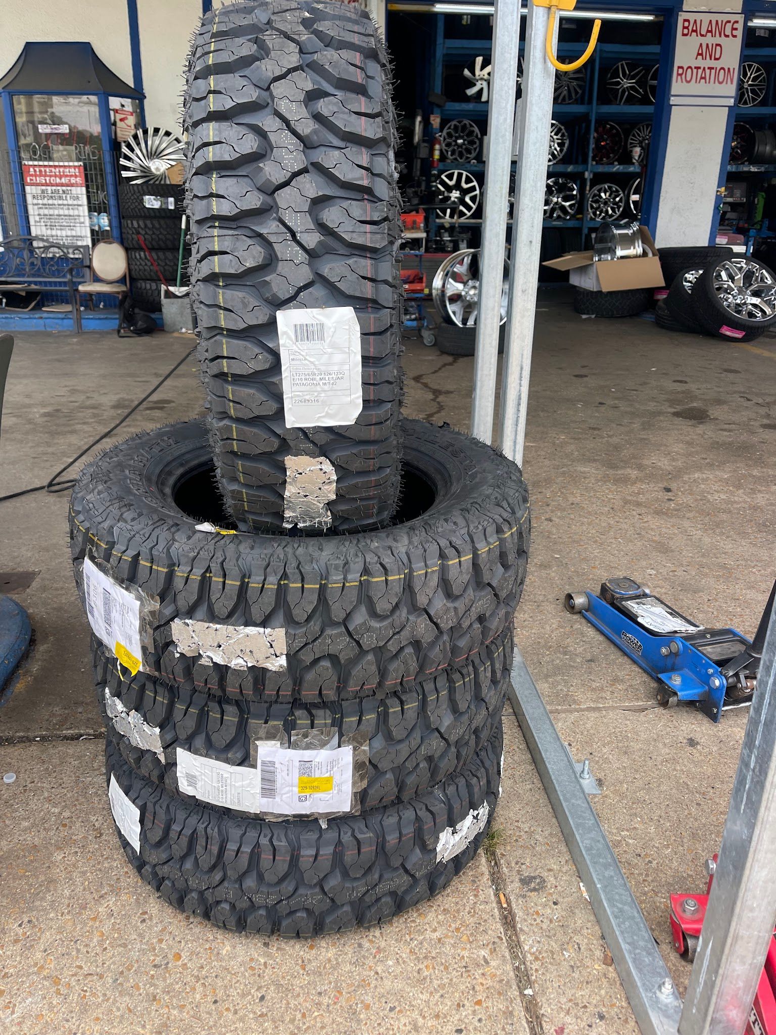 A stack of tires sitting on top of each other in a tire shop.