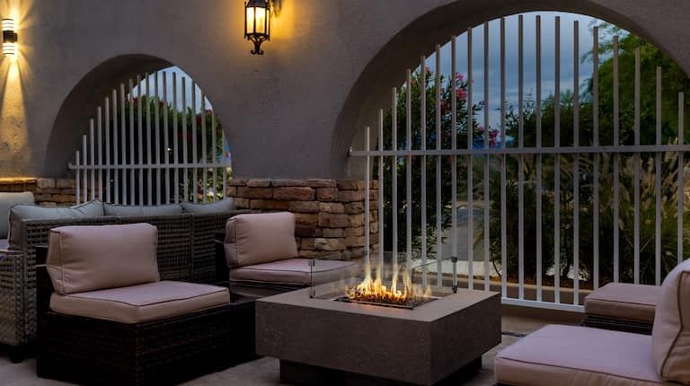 There is a fire pit in the middle of the patio.