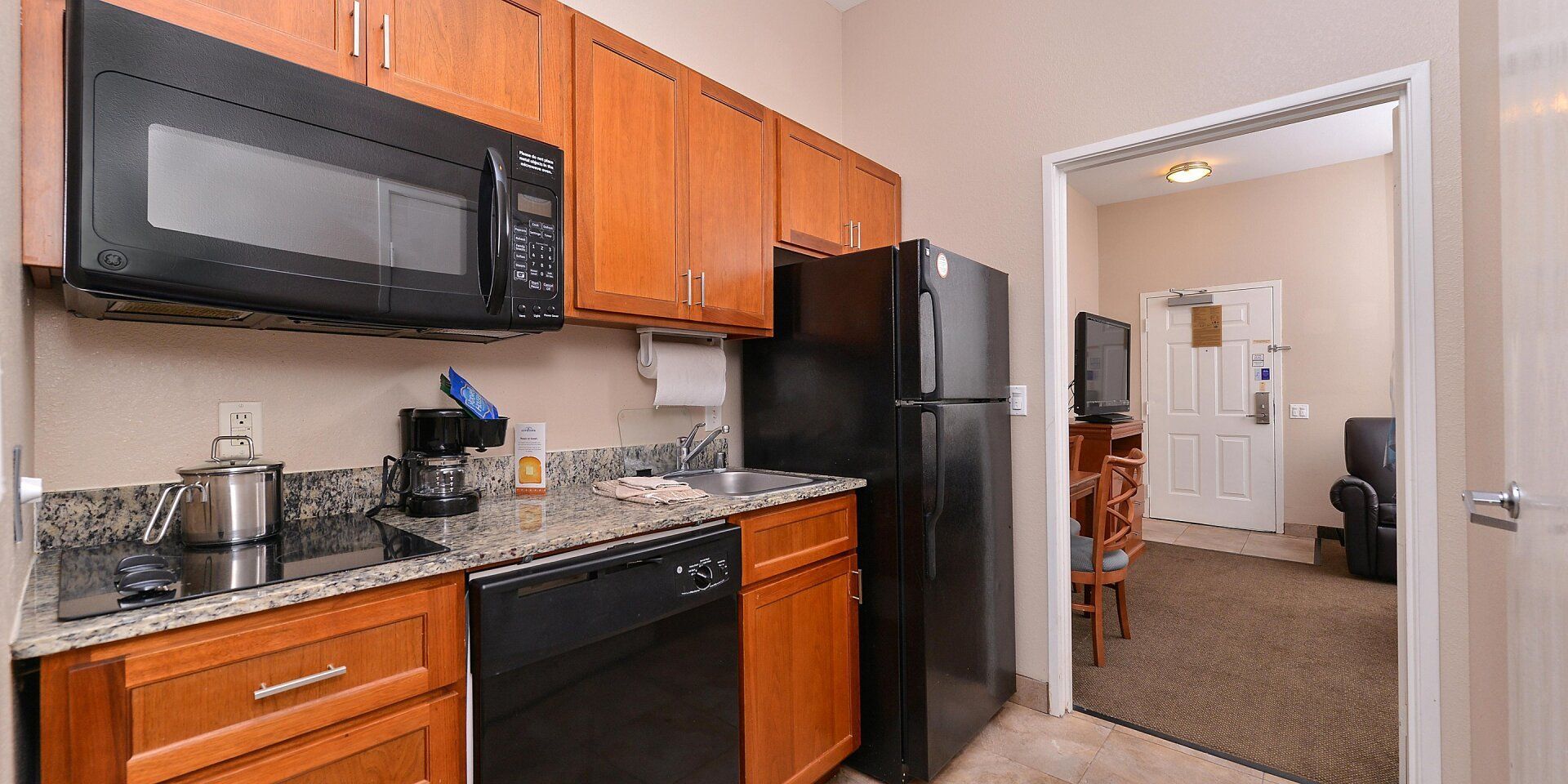 view of the hotel room kitchen area with microwave and fridge