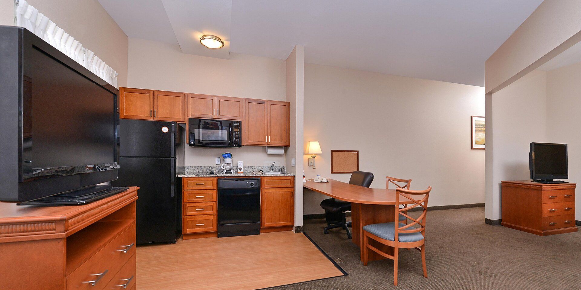 large kitchen and living room area of hotel room