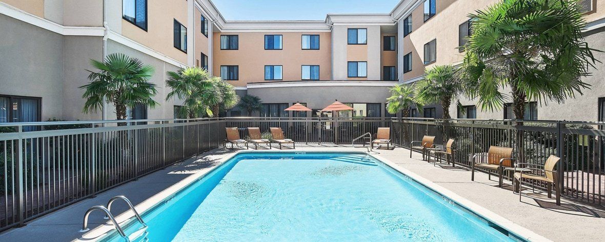 view of the hotel pool surrounded by the hotel building