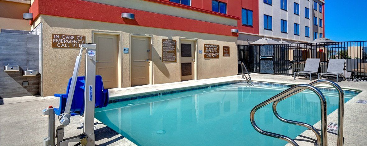 view to the hotel pool with the hotel building in the background