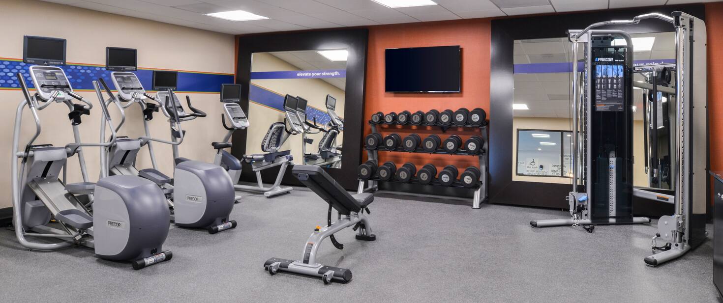 view of the indoor fitness area with free weight elliptical machines