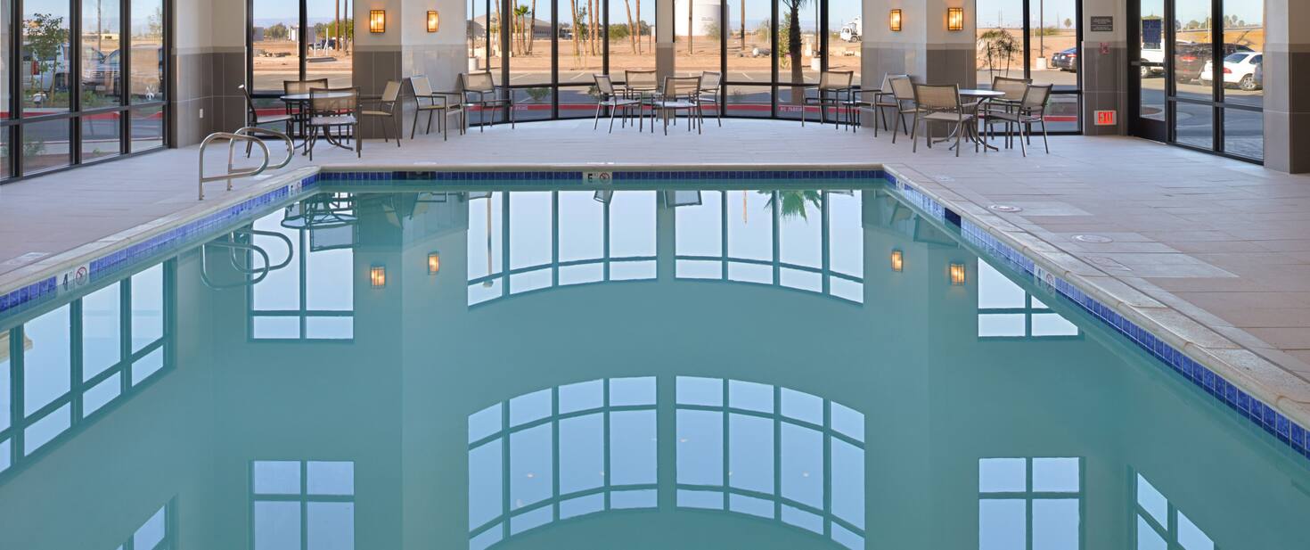 view of the indoor hotel pool and a glass window