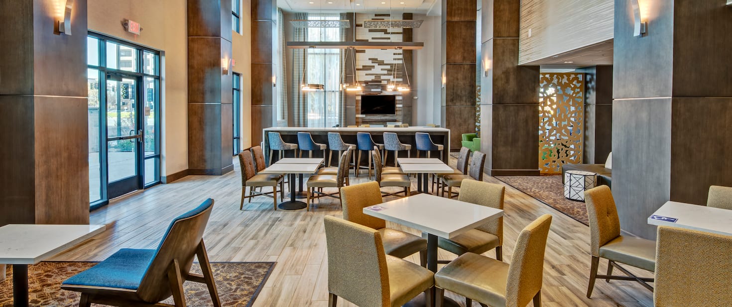 view of the hotel lobby with multiple tables and chairs