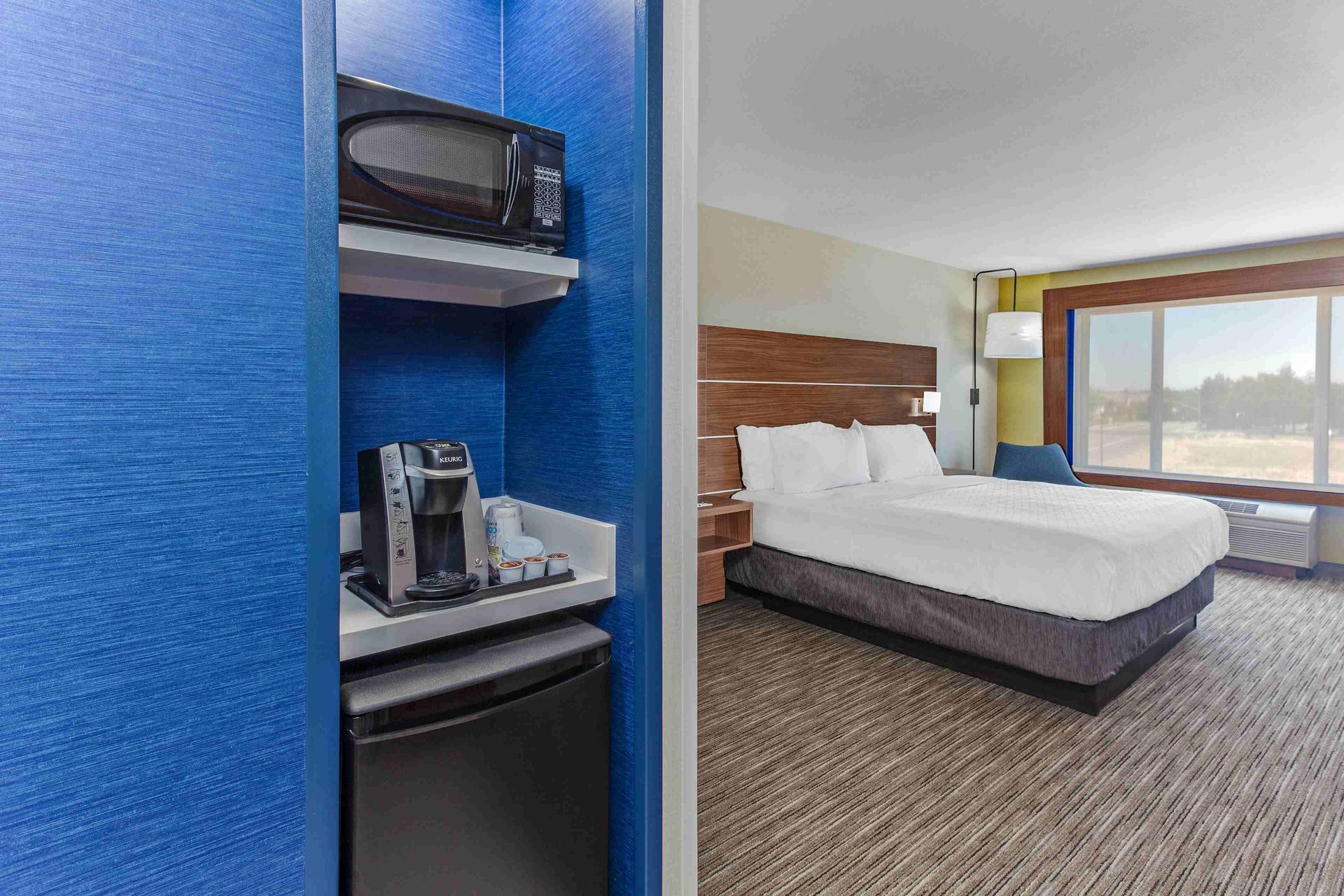 view to the hotel bed, microwave and minifridge