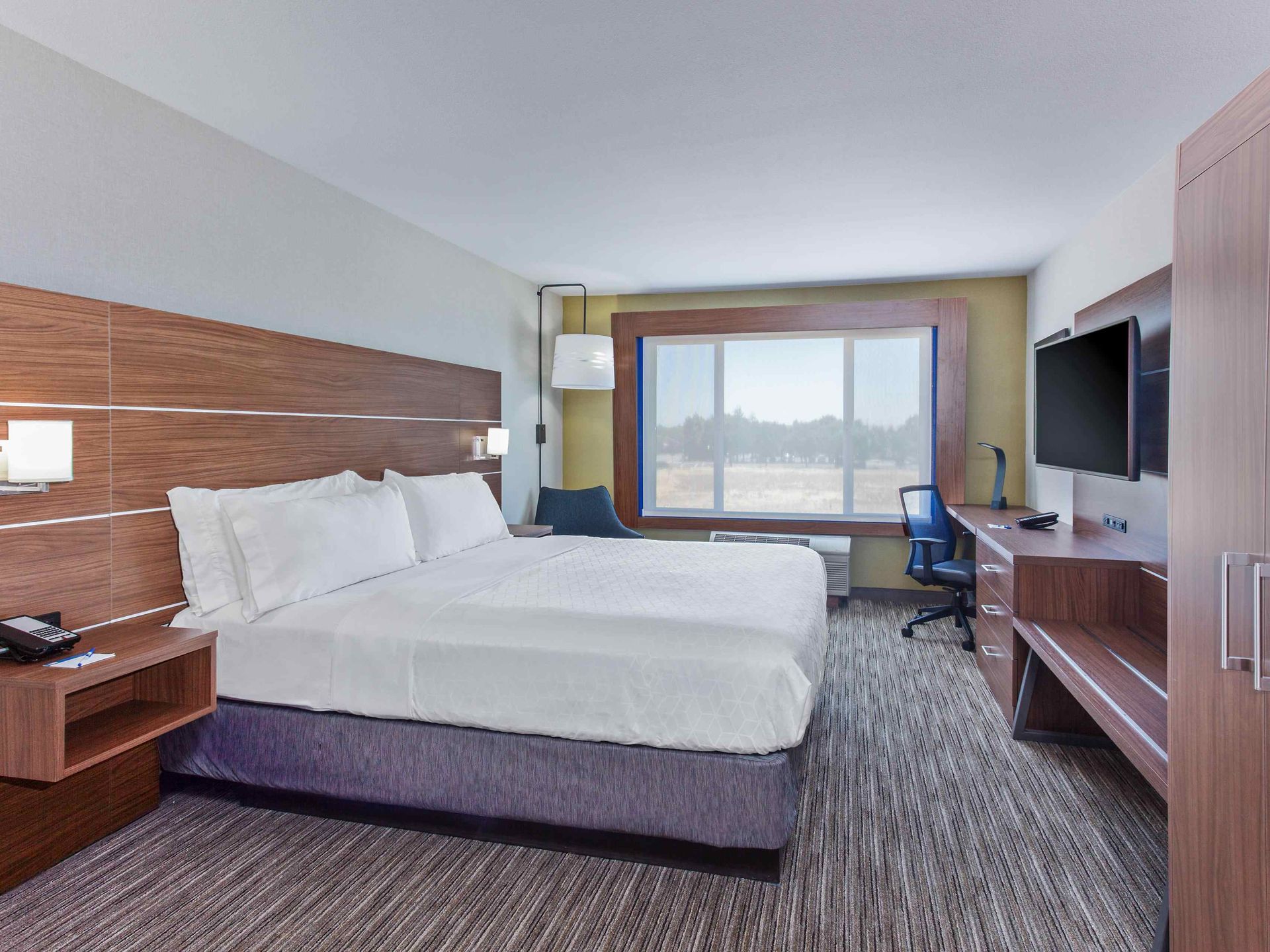 view to the hotel beds with a window view of the outdoors
