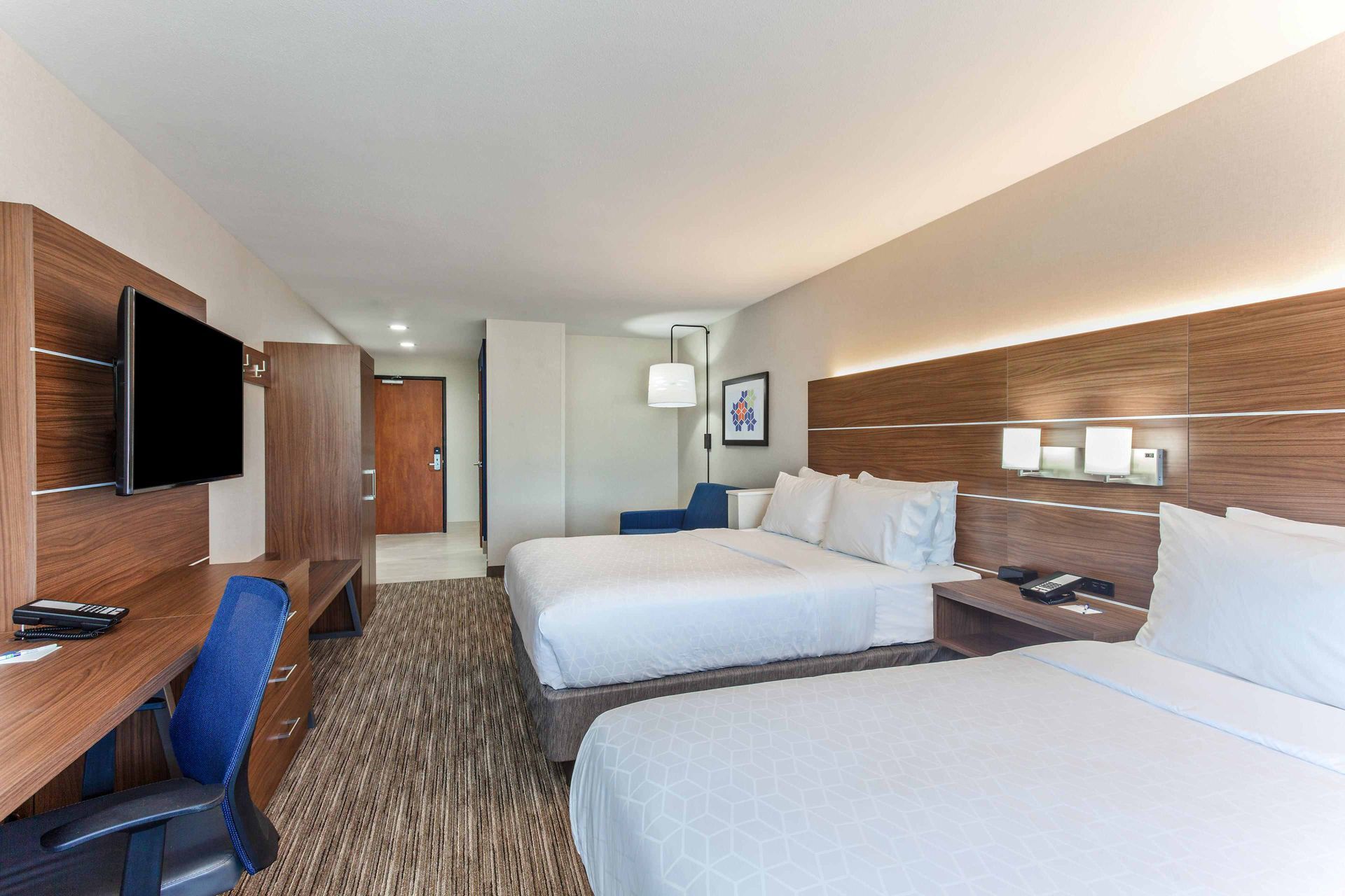 view to the hotel beds with brown wooden walls
