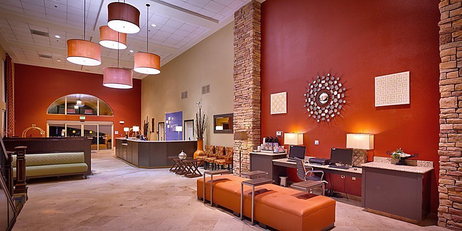 view of the hotel lobby with orange walls and decorative lamps