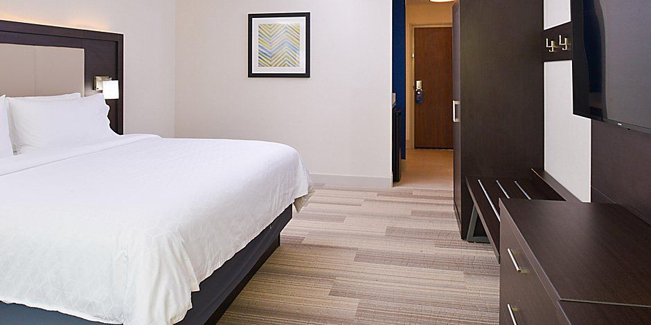 close up of hotel bed with the door open