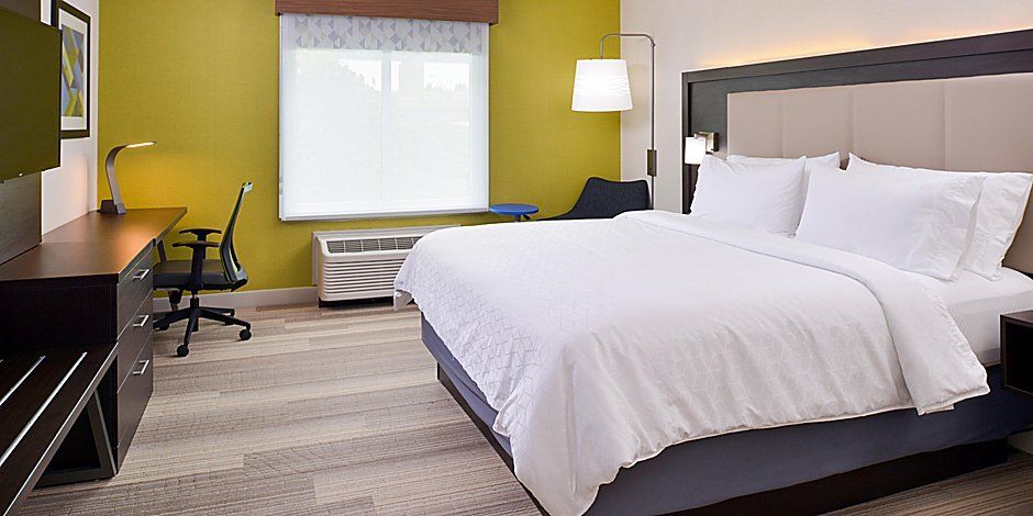 white comfortable large bed with a view to the window
