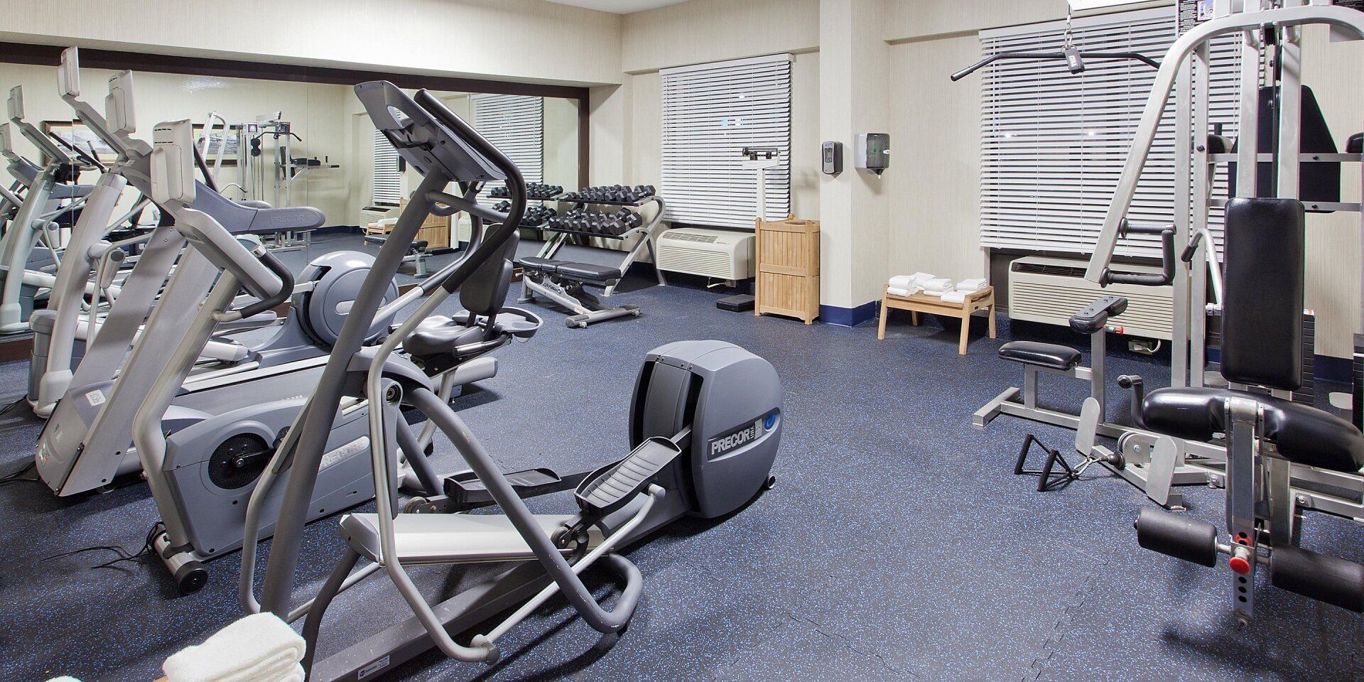 hotel fitness center with elliptical machine and weights