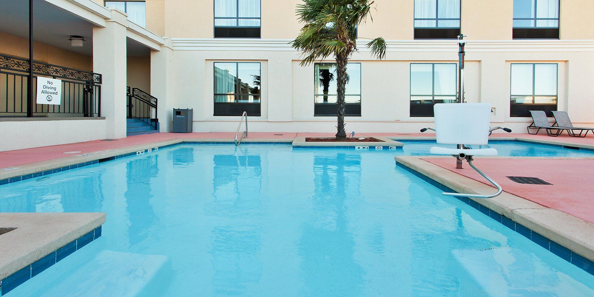 view to the large hotel pool with the hotel in the background