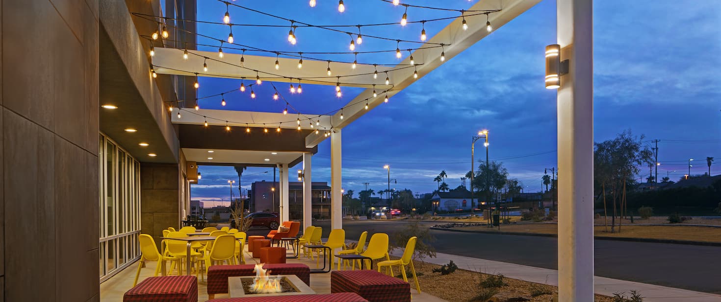 exterior lounge view of the the hotel showing multiple chairs and tables